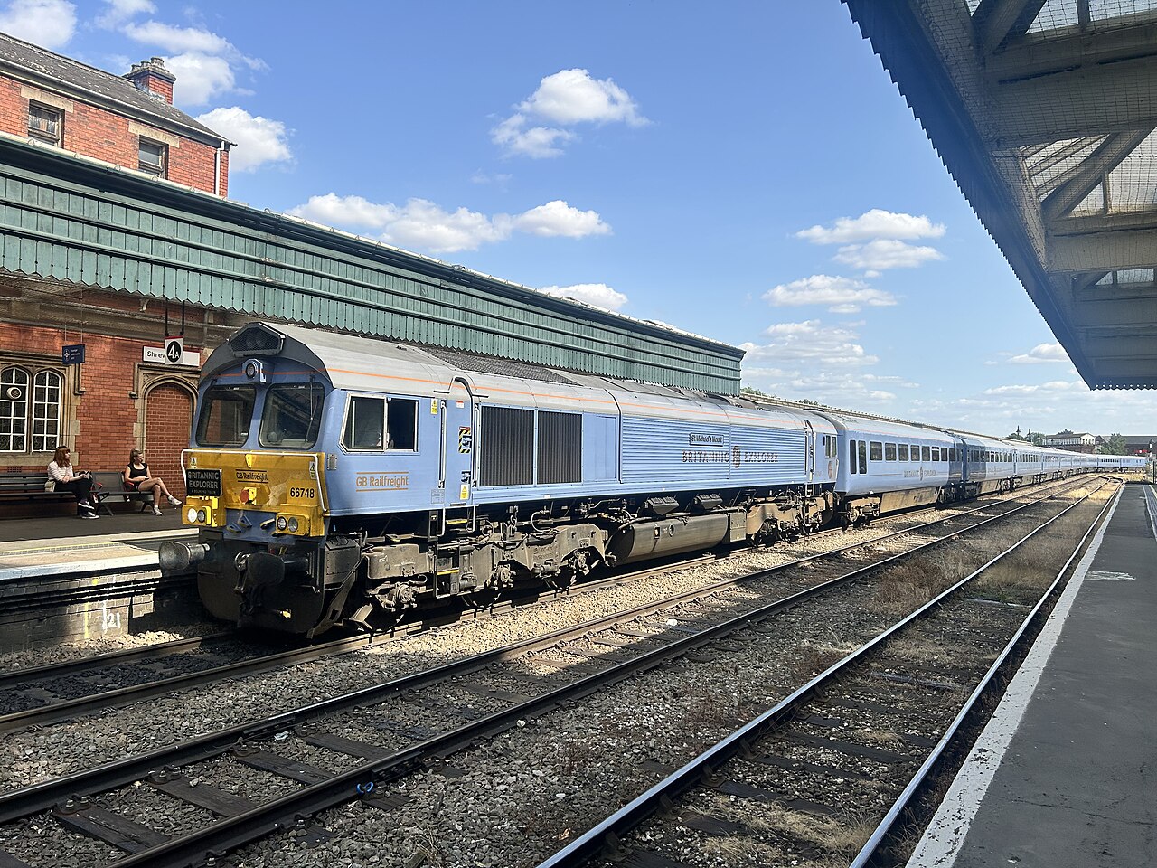 Locomotive and silver-blue Britannic Explorer carriages at Shrewsbury station
