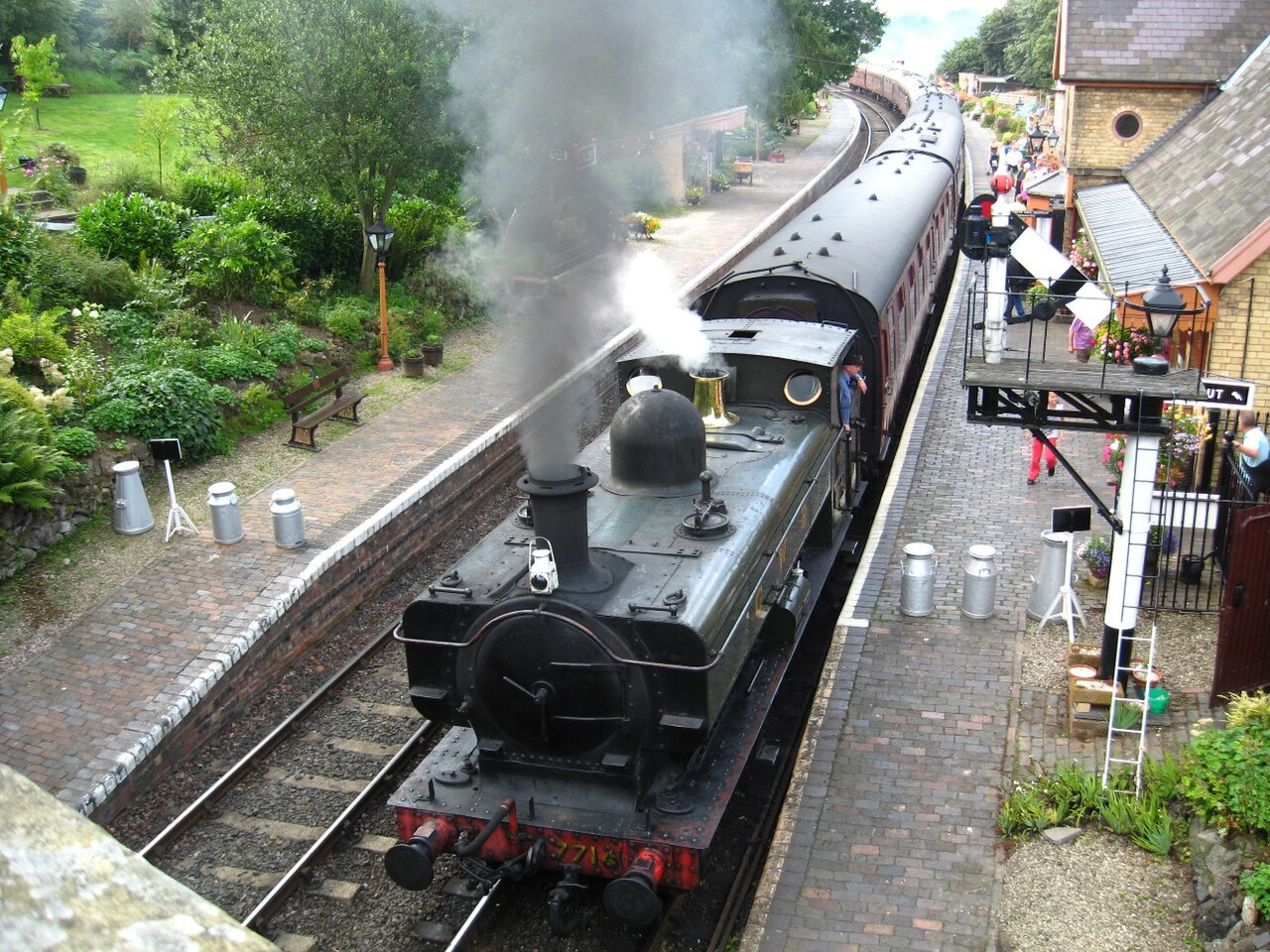 Green Severn Valley Railway steam locomotive and passenger cars at Arley station