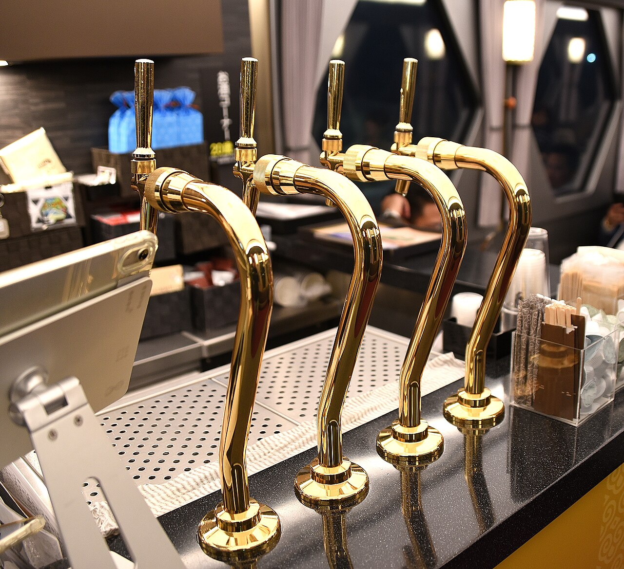 Polished gold beverage taps in the SPACIA X onboard café