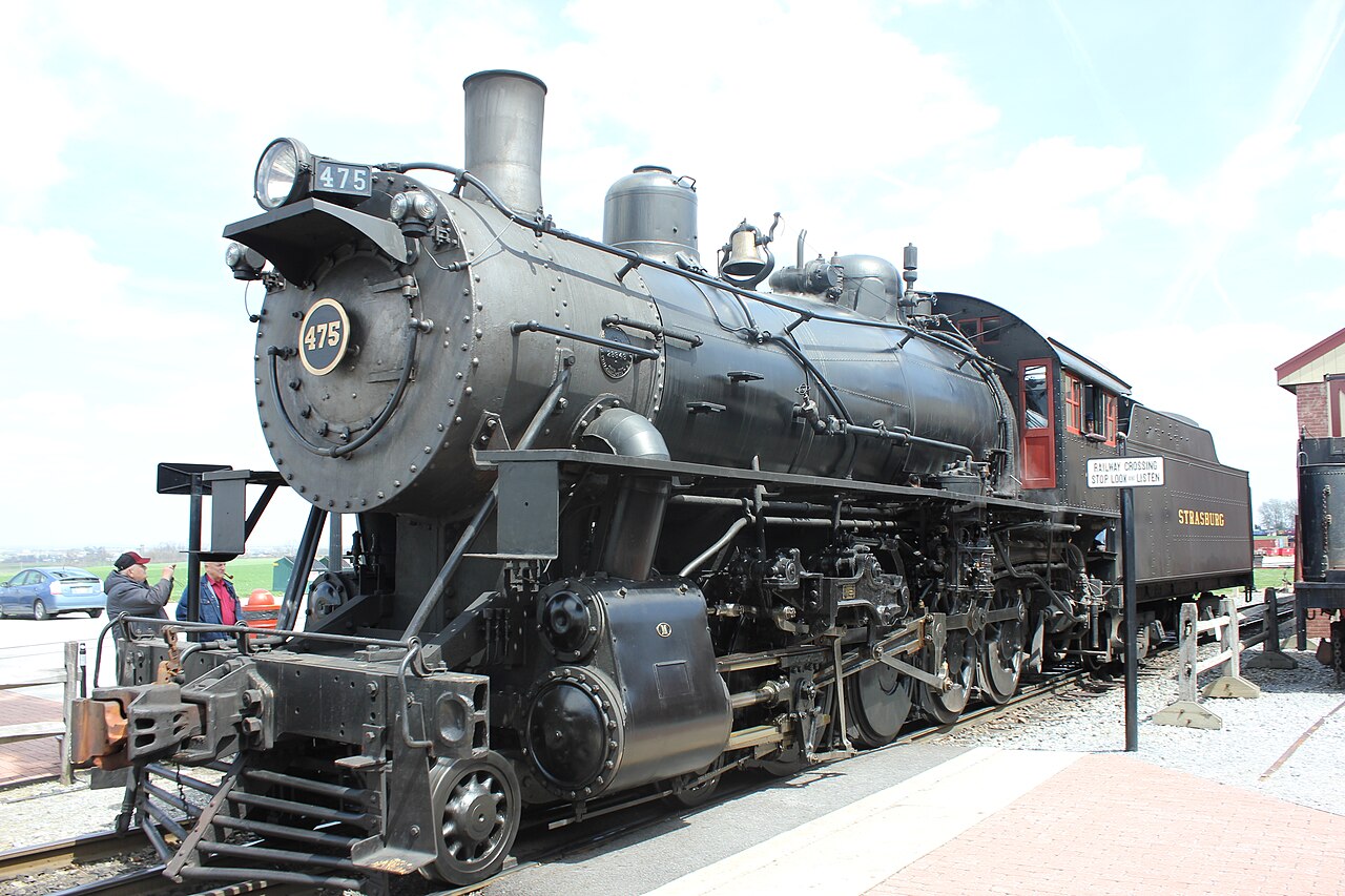 Black Strasburg Rail Road steam locomotive 475 beside the station platform