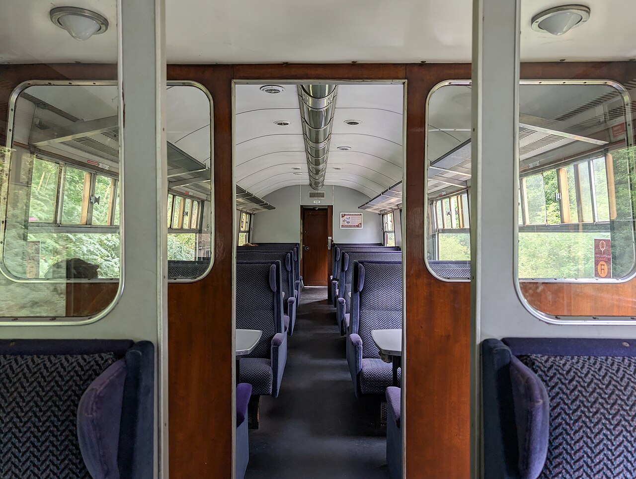 Heritage passenger seating and wood-framed partitions inside a West Somerset Railway carriage